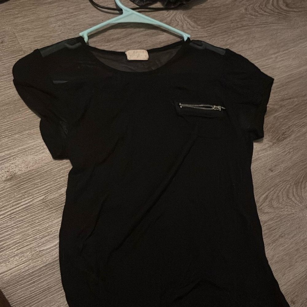 black shirt with little pocket on the top corner and zipper